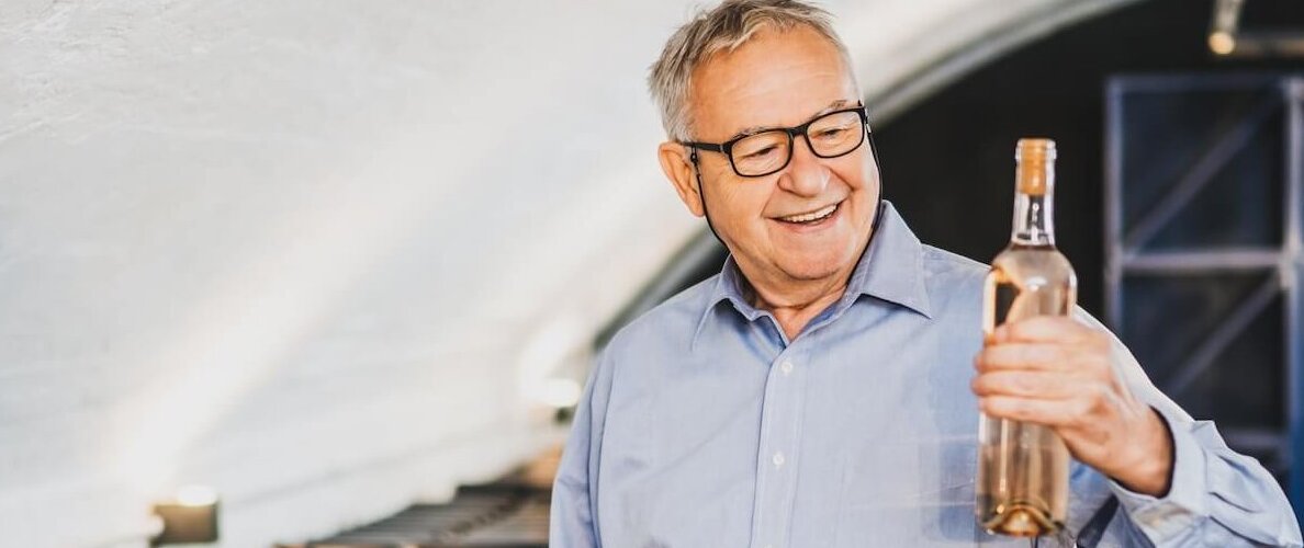 A winery CEO and founder inspecting bottles ready for distribution